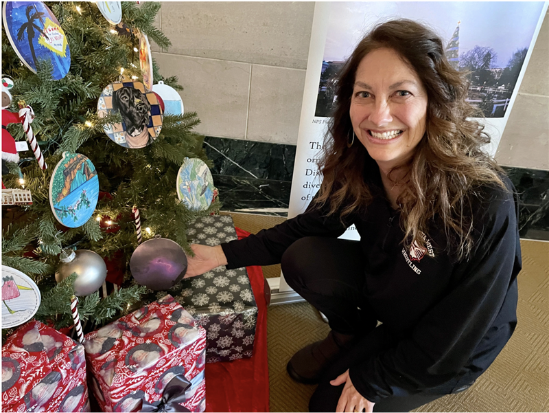 Jodi Kessler by a tree with ornaments