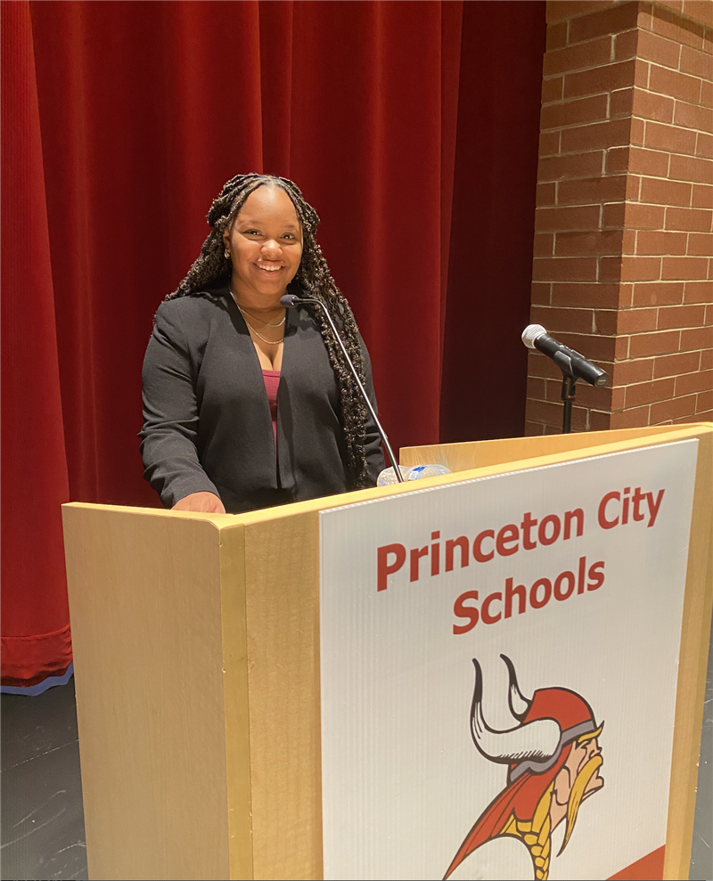 Marielle Smith stands at a podium.
