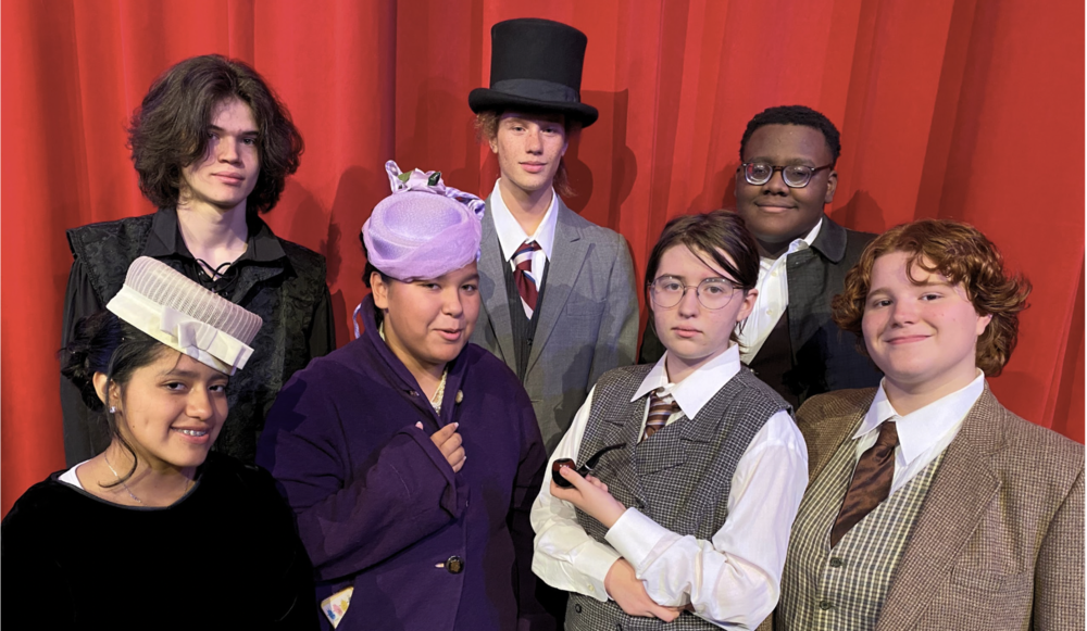 Cast of Sherlock Holmes in the costumes, in fromt of the red curtain in Matthews Auditorium 