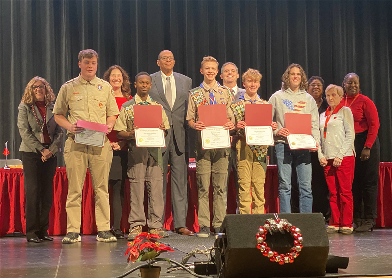 Eagle Scouts holding their awards